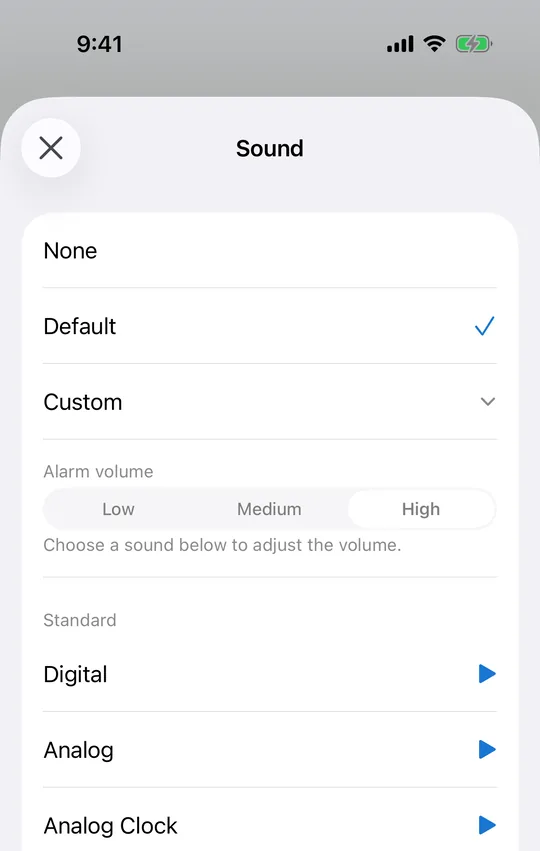 CAlarm's sound picker, with alarm volume set to Low, Medium or High above a list of sounds, each with a preview button