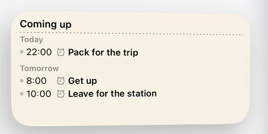 CAlarm's calendar widget on the Home Screen, listing Coming up: 22:00 Pack for the trip under Today, then 8:00 Get up and 10:00 Leave for the station under Tomorrow
